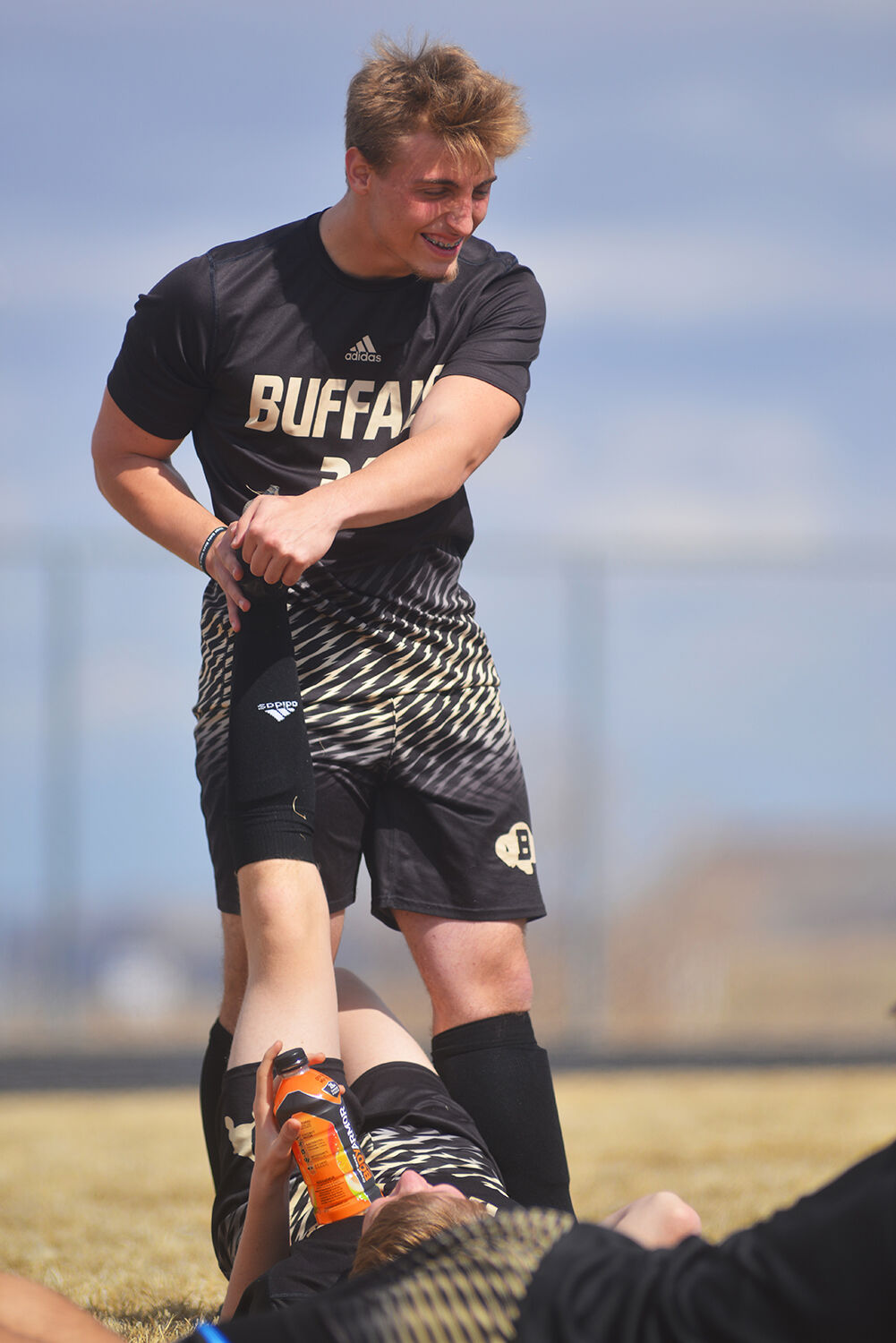 Aiden O’Neill helps a teammate stretch